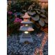  A garden figure of a pagoda, a Japanese lamp, a lantern