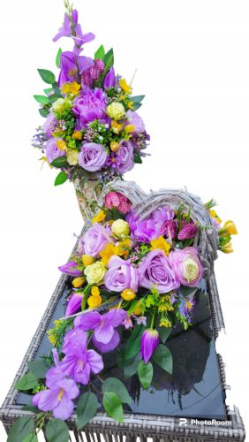  A set of gravestones, a bouquet of flowers for the grave, an All Saints basket